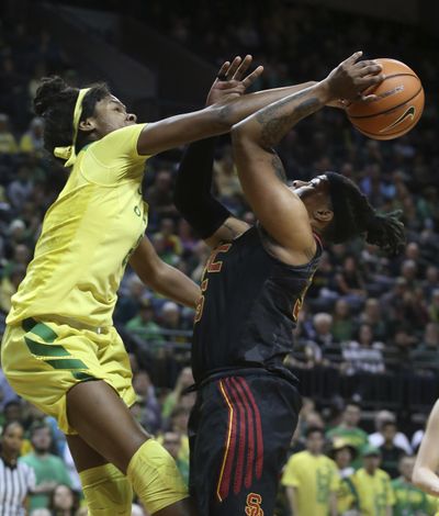 Oregon's Ruthy Hebard, left, blocks a shot by South California's Kristen Simon during the first half of an NCAA college basketball game Friday, Feb. 16, 2018, in Eugene, Ore. (Chris Pietsch/The Register-Guard via AP) ORG XMIT: OREUG101 (Chris Pietsch / AP)