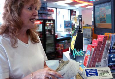 
Sally Heberling buys lottery tickets for  herself and 19 co-workers. 
 (Liz Kishimoto / The Spokesman-Review)