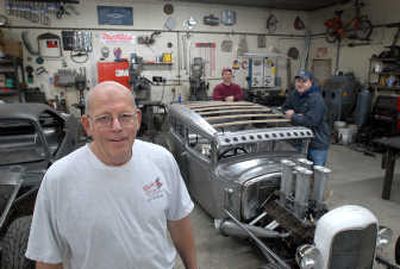 
Rich Gortsema, left, and his sons Brad, center, and Mike, right, stand by an unpainted car in the Spokane shop, Power Plus Inc. They're building it for a customer in Austrailia. 
 (JESSE TINSLEY Photos / The Spokesman-Review)