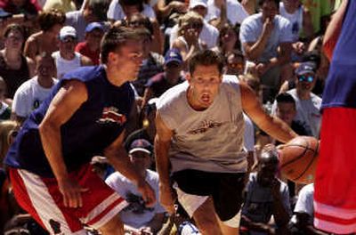 
Team Fresno's Tony Amundsen drives past a Rukus defender during a Hoopfest men's elite division game Saturday at Nike Center Court. 
 (J. Bart Rayniak / The Spokesman-Review)