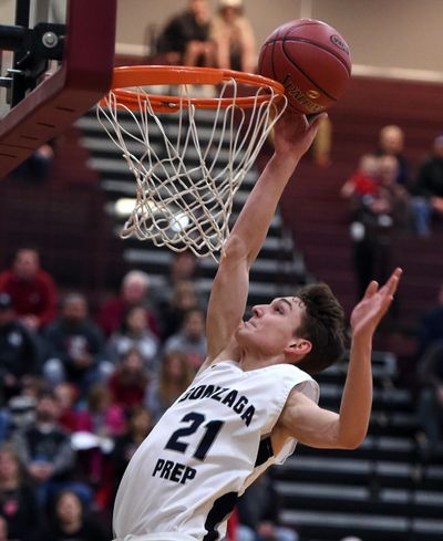 On a breakaway downcourt, Gonzaga Prep's Liam Lloyd scores 2 points against Sunnyside during the first half of a WIAA 4A regional playoff basketball game, Fri., Feb. 23, 2018, at University High School. (Colin Mulvany / The Spokesman-Review)
