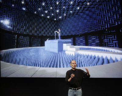 Apple CEO Steve Jobs talks about testing in a special room for the Apple iPhone 4 at Apple headquarters in Cupertino, Calif., on Friday. (Associated Press)
