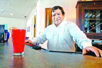
Tony Orozco owns and operates three restaurants, one in Spokane and two in Idaho. Here he's standing behind the bar at the Blue Bay restaurant  in Post Falls.  
 (Jesse Tinsley / The Spokesman-Review)