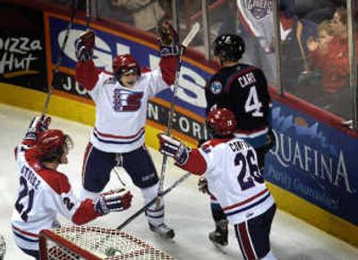 
Kyle Howarth, center, raises his hands in celebration along with Myles Stoesz, left, and Seth Compton after Compton scored his first goal as a Chief on Wednesday night against the Kelowna Rockets.
 (Jed Conklin / The Spokesman-Review)
