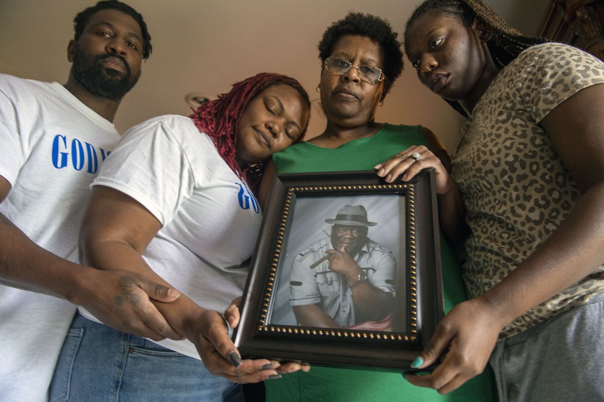 Janet Hartford, center, the wife of Anthony Hartford, 53, whose body was found among the dead on the Seacor Power, holds a photo of her husband while standing with her daughter, Antranae, 24, right, son, Thelonious Dukes, 38, far left, and daughter-in-law, Chantrice, at their home in New Orleans on Saturday, April 17, 2021. Divers returned Saturday to the murky, roiling waters of the Gulf of Mexico in search of lost crew members aboard a capsized lift boat off Louisiana, the Coast Guard said.  (CHRIS GRANGER)