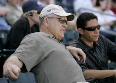 
Associated Press photos Texas Rangers president Nolan Ryan, left, confers with team general manager Jon Daniels during a spring training game.
 (Associated Press photos / The Spokesman-Review)