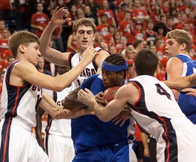 Gonzaga's Grant Gibbs, from left, Andy Poling and Chris Pontarolo-Maag battle for the ball against Indiana-Purdue Fort Wayne's Antwone Sead in the first half of their NCAA college basketball game at McCarthey Athletic Center in Spokane, Wash. Friday, Nov. 20, 2009. (Rajah Bose / Fr120940 Ap)