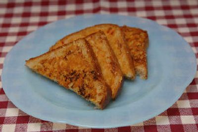 
Quick Fix Texas Cheese Toast is prepared on one side with margarine and cheese.
 (Elaine Magee / The Spokesman-Review)