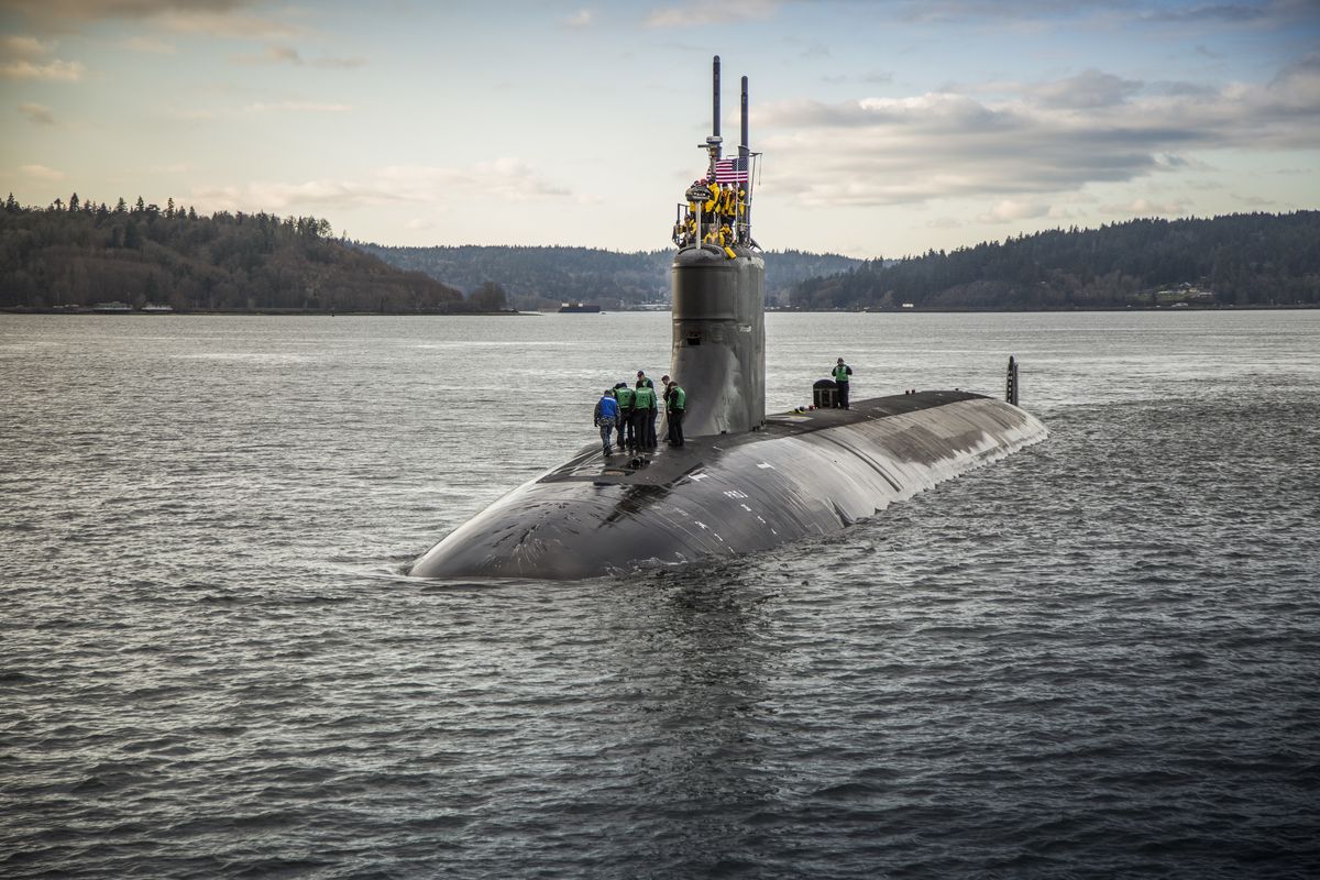 In this Dec. 15, 2016 photo, provided by the U.S. Navy, the Seawolf-class fast-attack submarine USS Connecticut (SSN 22) departs Puget Sound Naval Shipyard for sea trials following a maintenance availability. A Navy official says a submarine that collided with an unknown underwater object in the South China Sea has arrived in port at Guam. The Navy says the USS Connecticut was conducting routine operations when it struck the object on Oct. 2, 2021.  (Thiep Van Nguyen II)