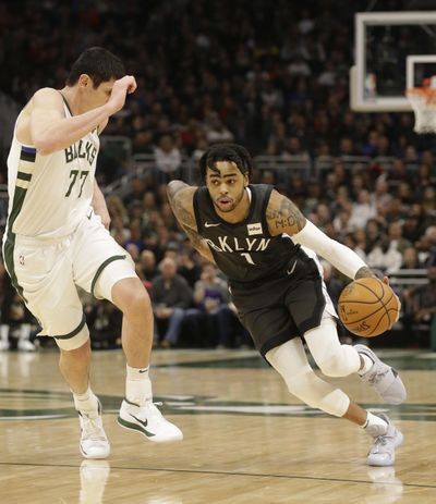 Brooklyn Nets’ D’Angelo Russell, right, drives against the Milwaukee Bucks’ Ersan Ilyasova, left, during the second half of an NBA basketball game Saturday, April 6, 2019, in Milwaukee. (Jeffrey Phelps / Associated Press)