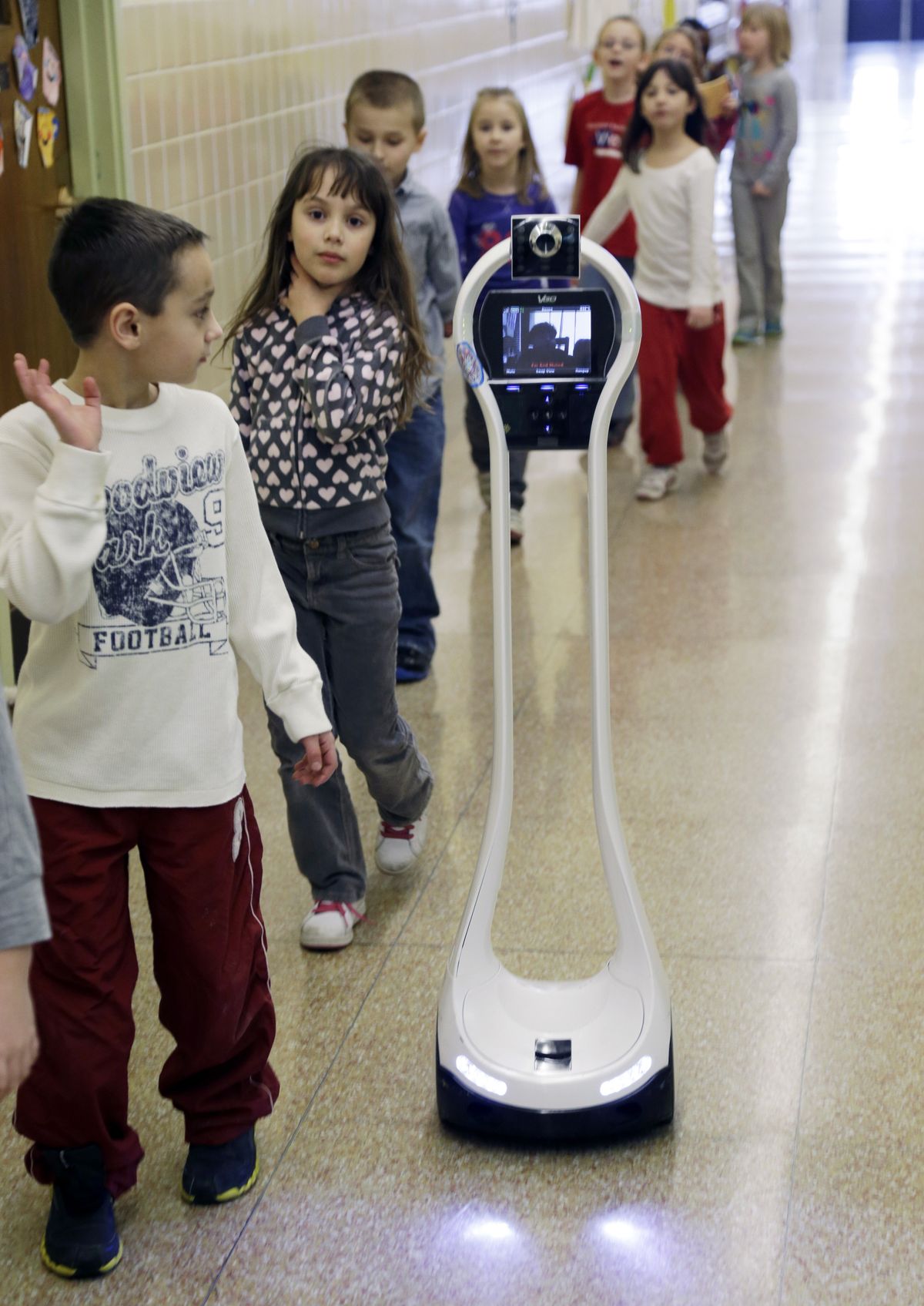 Devon Carrow attends Winchester Elementary School from home while operating a robot in the school, in West Seneca N.Y. Carrow’s life-threatening allergies don’t allow him to go to school. With the 4-foot-tall robot Devon can experience school remotely. (Associated Press)