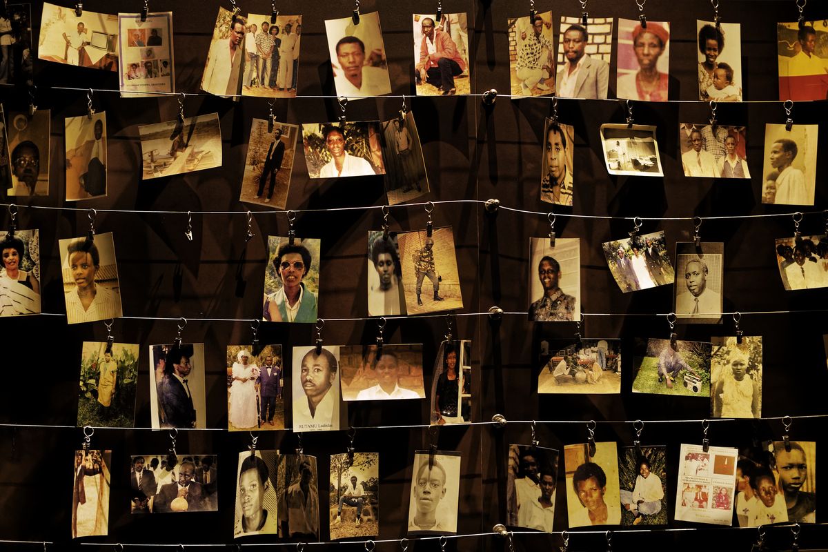 Family photographs of some of those who died hang on display in a 2019 exhibition at the Kigali Genocide Memorial center in the capital of Kigali, Rwanda.  (Ben Curtis)