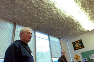 
During a recent informational tour, Coeur d'Alene School District Maintenance Supervisor Bryan Martin, left, said  he looks forward to removing the spray-on ceiling texture that is in most of the Lakes Middle School classrooms. 
 (File / The Spokesman-Review)