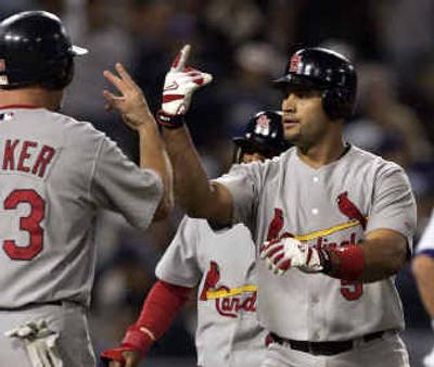 
St. Louis' Larry Walker, left, congratulates fellow slugger Albert Pujols after Pujols' three-run home run against the Dodgers on Thursday. 
 (Associated Press / The Spokesman-Review)
