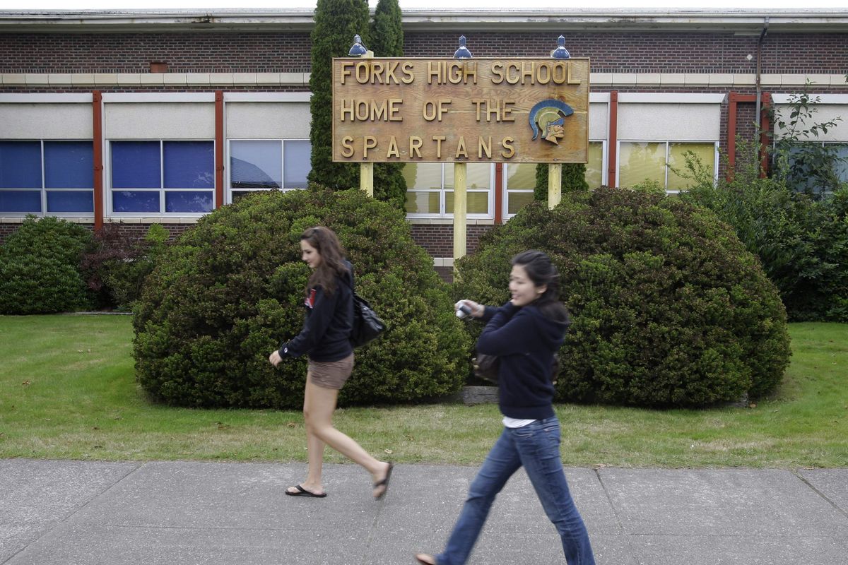 Parisa Sadrzadeh, left, and Yena Hu, both of Seattle, walk past Forks High School, where portions of author Stephenie Meyers’ vampire-themed “Twilight” books are set. Associated Press file photos (Associated Press file photos)