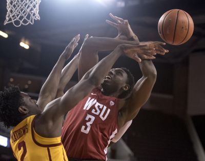 Washington State forward Robert Franks, right, is fouled by Southern California guard Jonah Mathews during the first half of an NCAA college basketball game Sunday, Dec. 31, 2017, in Los Angeles. (Kyusung Gong / AP)
