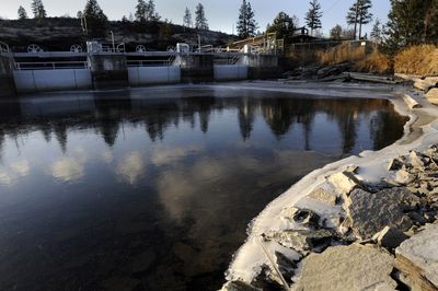Ice and driftwood surround the Post Falls Dam spillway Tuesday on the Spokane River in Post Falls.   (Jesse Tinsley / The Spokesman-Review)