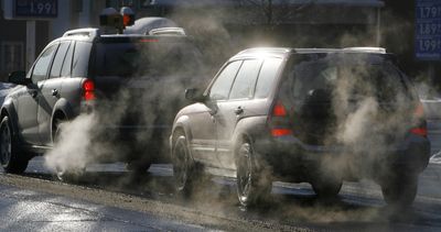 Cars give off exhaust fumes Monday in Montpelier, Vt. Efforts by Vermont and 13 other states to cut carbon dioxide emissions from vehicles are expected to get a big boost from President Barack Obama.  (Associated Press / The Spokesman-Review)