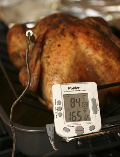 Federal guidelines state that turkey is safe to eat when the innermost part of the thigh reaches 165 degrees. Stuffing inside the turkey must also reach  165 degrees.  (Associated Press)