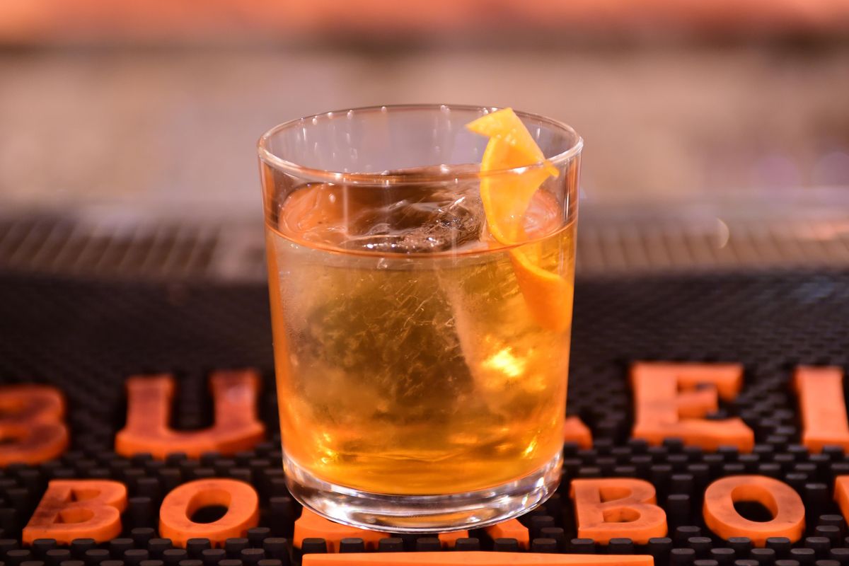 Simon Moorby, bartender at Hogwash Whiskey Den in the Washington Cracker Building, says the old-fashioned is the classic American cocktail because it combines bourbon or whiskey with various flavors to create the perfect taste. Photographed Monday, May 8, 2017. (Jesse Tinsley / The Spokesman-Review)