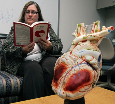 Kathy Ackerman, nurse manager of the Akron Children’s Hospital Heart Center, reads in the hospital’s library on Dec. 7 in Akron, Ohio.