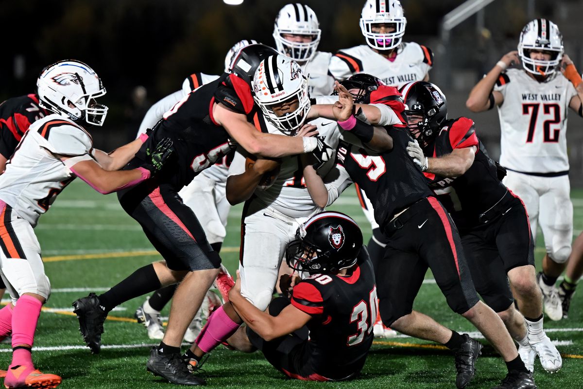 West Valley quarterback Raesean Eaton is swarmed by North Central’s defense during a keeper play in the first half of a high school football game Thursday at Union Stadium in Mead.  (COLIN MULVANY/THE SPOKESMAN-REVIEW)