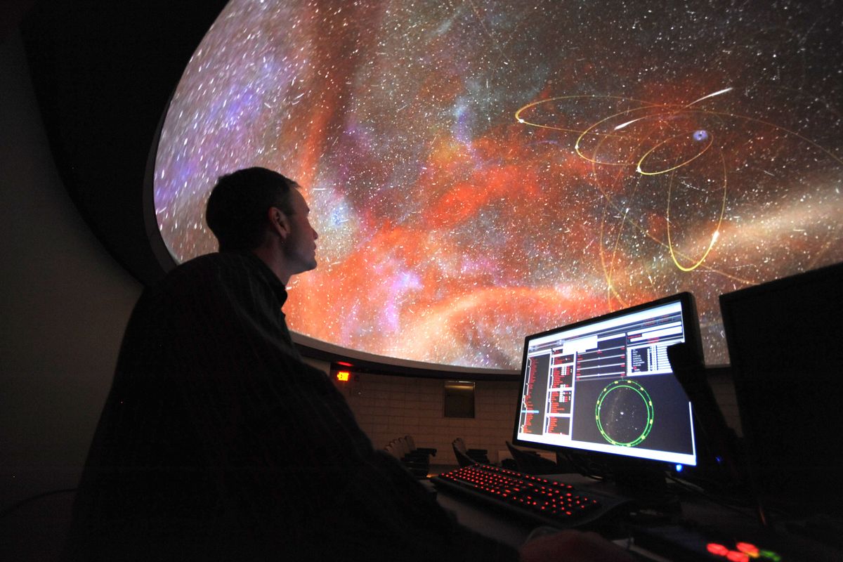 Astronomy instructor John Whitmer looks up at the simulated night sky as he operates the software of the new planetarium classroom at Spokane Falls Community College. In addition to classes, the planetarium will host field trips for K-12 students and eventually be open to the public. (Jesse Tinsley)