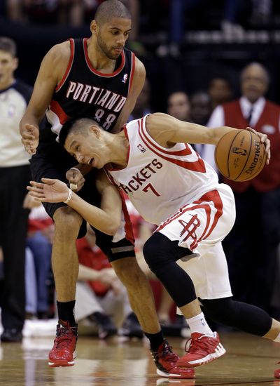 Nicolas Batum, who had 14 points and nine rebounds for the Blazers, defends Houston’s Jeremy Lin in the second quarter. (Associated Press)