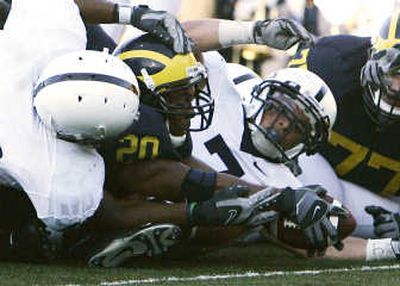 
Michigan's Mike Hart reaches out a 1-yard, fourth-quarter rushing TD. Associated Press
 (Associated Press / The Spokesman-Review)