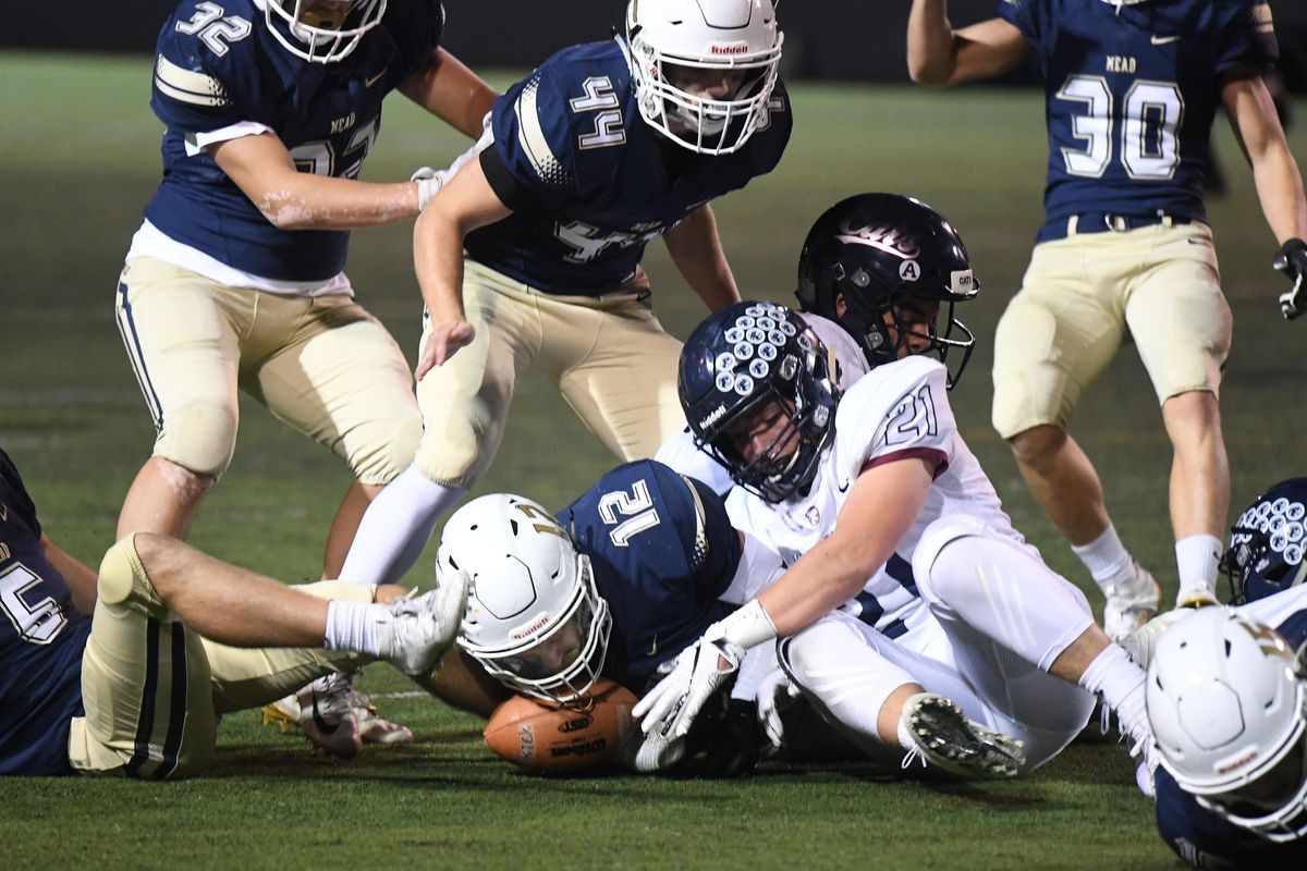 Mead running back Parker Startin (12) recovers a Mt Spokane fumble on a kick off return in the first quarter of a GSL high school football game, Fri., Sept. 27, 2019, at Joe Albi Stadium. . (Colin Mulvany / The Spokesman-Review)