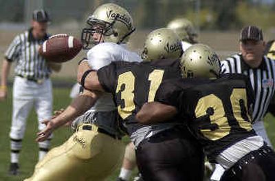 
Tight end Peter Bjorvik is stripped of the ball by linebackers Josh Bousman (31) and John Williams (30) Saturday in a scrimmage at Post Falls High School.
 (Tom Davenport/ / The Spokesman-Review)