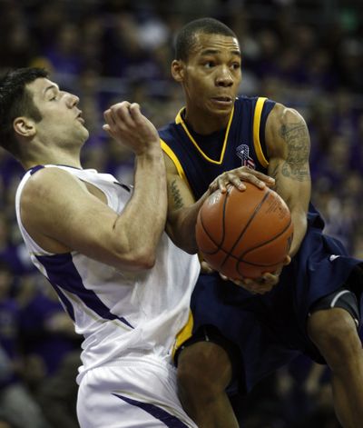 Cal’s Jerome Randle, right, draws a blocking foul against  Jon Brockman.  (Associated Press / The Spokesman-Review)