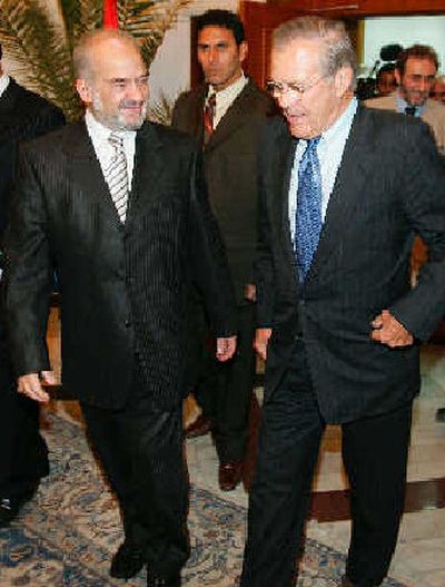 
Iraqi Prime Minister Ibrahim al-Jaafari, left, walks with U.S. Secretary of Defense Donald H. Rumsfeld to a meeting Wednesday in Baghdad, Iraq. Al-Jaafari said it is the preference of the Iraqi government that U.S. troops withdraw as soon as possible.
 (Associated Press / The Spokesman-Review)