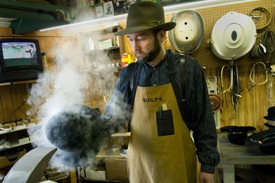 Dave Wolf, owner of Wolf’s Hattery and Mercantile, steams a fedora in his  Northwest Boulevard  shop Wednesday. Wolf says more people are buying fedoras.  (Colin Mulvany / The Spokesman-Review)