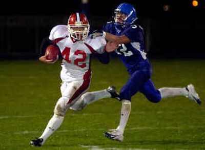
Sandpoint Bulldogs' running back Dan Parrish (42) tries to break free from Coeur d'Alene Vikings' Alex Howard Friday night at Coeur d'Alene High School. 
 (Tom Davenport/ / The Spokesman-Review)