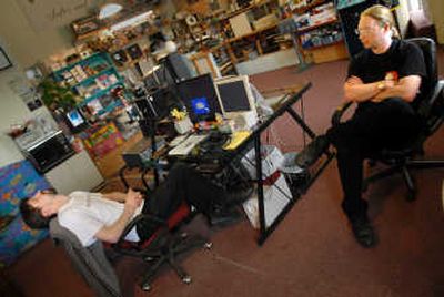 
Ben Amos, left, and John Swiderski, of Mean Hamster Software, confer on writing code  for a new video game Wednesday in Deer Park. 
 (Brian Plonka / The Spokesman-Review)