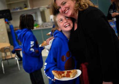 
Moran Prairie counselor Jacquie Johansson gets a hug from fifth-grader Caitlin Prothe after the peer group leaders were surprised with a pizza party.
 (Brian Plonka / The Spokesman-Review)