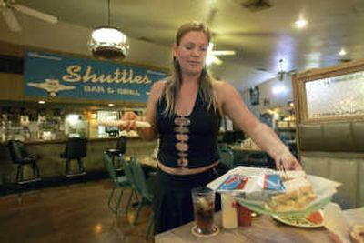 
Dayna Watson serves customers last month at Shuttles Bar & Grill in Merritt Island, Fla., on May 22. Shuttles, the closest watering hole for Kennedy Space Center employees, is also a popular spot for tourists to watch launches. Associated Press photos
 (Associated Press photos / The Spokesman-Review)