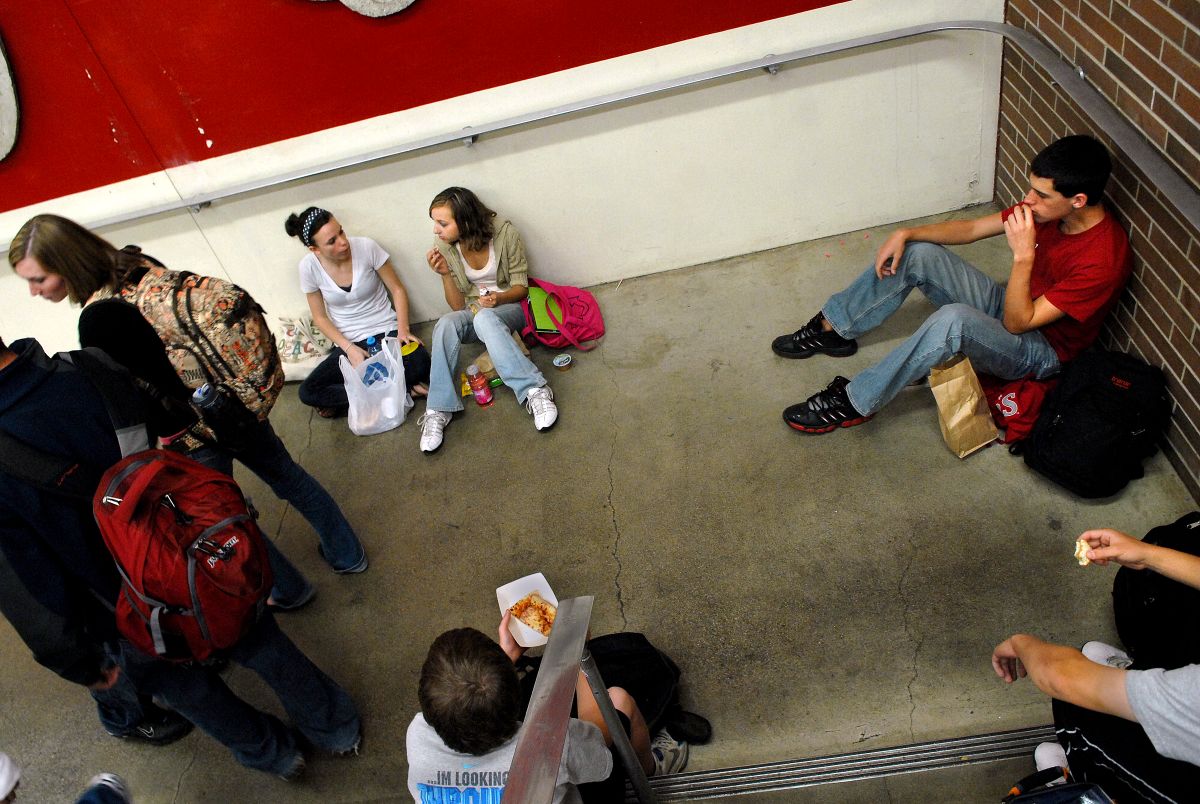 Ferris High School students eat lunch in a stairwell on Thursday. The lunchroom has limited seating, forcing some to find alternative locations. (Photos by BRIAN PLONKA / The Spokesman-Review)