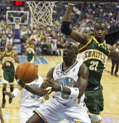 
New Orleans guard Bobby Jackson shoots in front of Seattle center Johan Petro during the second quarter.
 (Associated Press / The Spokesman-Review)