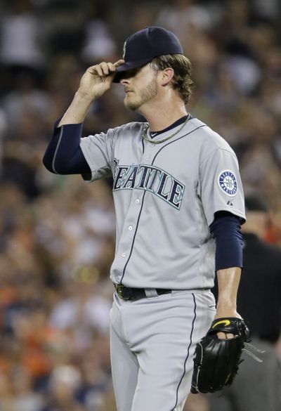 Mark Lowe can barely watch as the Mariners lose another close one last Monday. (Associated Press)