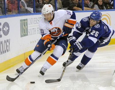 In this March 14, 2013, file photo, New York Islanders center Keith Aucoin (10) controls the puck ahead of Tampa Bay Lightning defenseman Matt Carle (25) during the third period of an NHL hockey game, in Tampa, Fla. The morning after the NHL announced it wasnt going to the 2018 Olympics, some Americans playing in Europe started wondering if they should keep their schedules open. Aucoin is among the leaders in Germany. (Brian Blanco / Associated Press)