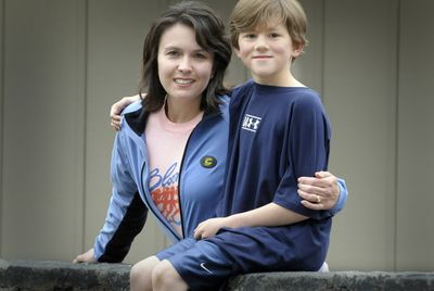 Jody Stirpe  and son Jacob pause before a Bloomsday training run Wednesday. Stirpe plans to upload race photos after they finish Sunday.  (Christopher Anderson / The Spokesman-Review)