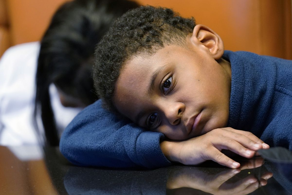 Jhaimarion, 10, reacts as he listens to his mother, Krystal Archie, talking Sept. 23 with an Associated Press reporter in Chicago.  (Nam Y. Huh)