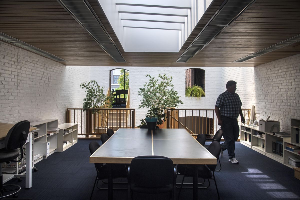 Dave Mendez, construction manager, walks through the upstairs conference area for Roen Associates Inc., a Spokane-based construction consulting firm, Aug. 11, 2017. They have leased a historic downtown building once occupied by Kenneth Brooks, a renowned midcentury architect and urban planner. (DAN PELLE/The Spokesman-Review)