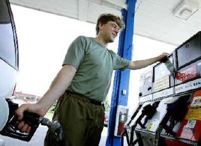 
Mike Jorgenson of Eagan, Minn., is dismayed to learn that gasoline prices are headed higher as he fills his 1997 Chevy Blazer SUV. Oil prices Monday rose to a new high near $60 a barrel. 
 (Associated Press / The Spokesman-Review)