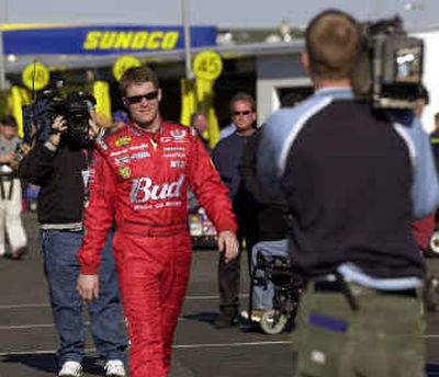 
TV cameras follow Dale Earnhardt Jr. as he cruises the Daytona International Speedway garage area. 
 (Associated Press / The Spokesman-Review)