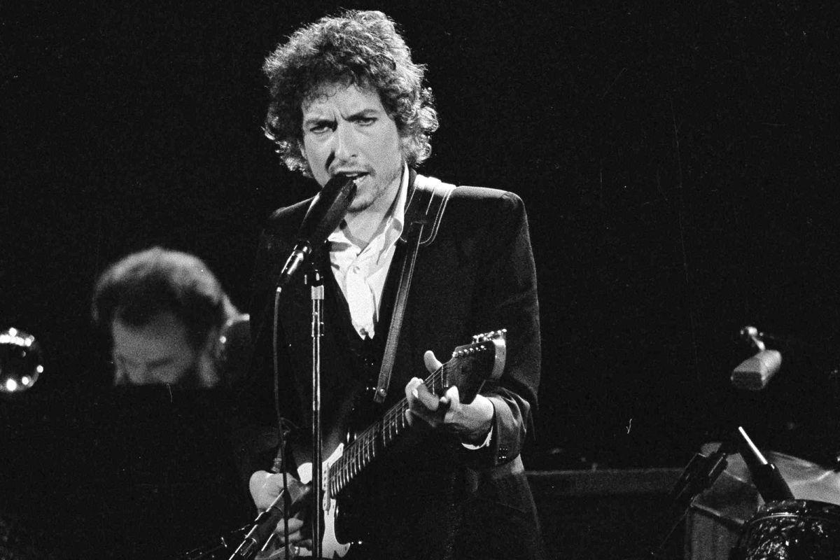 Musician Bob Dylan performs with The Band at the Forum in Los Angeles on Feb. 15, 1974. Transcripts of lost 1971 Dylan interviews with the late American blues artist Tony Glover and letters the two exchanged reveal that Dylan changed his name from Robert Zimmerman because he worried about anti-Semitism, and that he wrote "Lay Lady Lay" for actress Barbra Streisand. The items are among a trove of Dylan archives being auctioned in November 2020 by Boston-based R.R. Auction.  (Jeff Robbins)