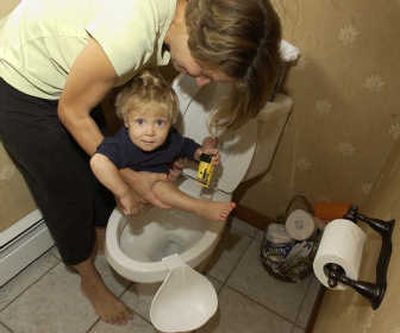 
Erinn Klatt holds her 13-month-old son, Dominic,  over the toilet at their home in Sutton, Mass. Associated Press
 (Associated Press / The Spokesman-Review)