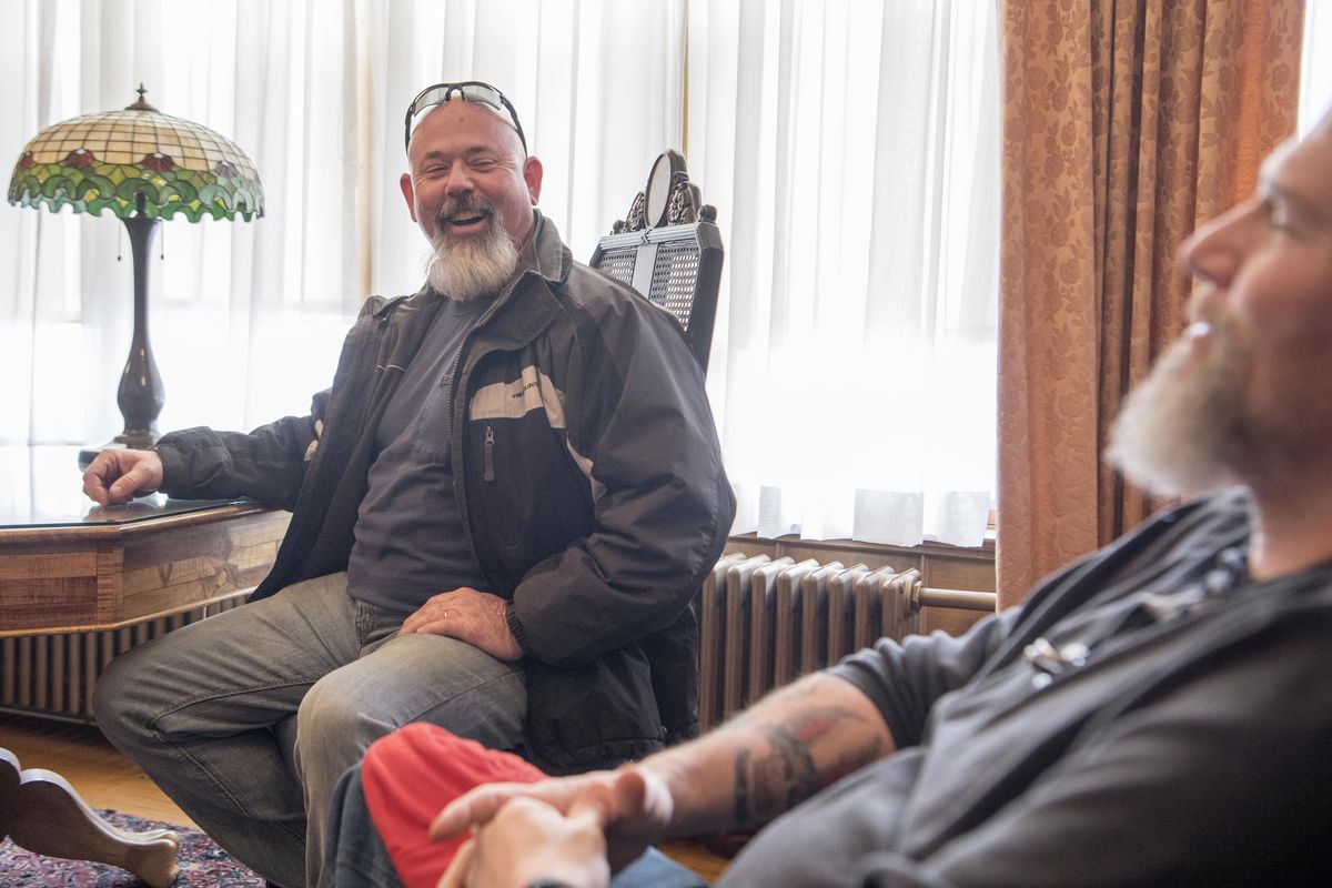 Nick Nickelson, left, laughs while his older brother Dave Johnson, right, tells the story of how they found each other through DNA matching and sleuths on the internet Friday, Feb. 23, 2018 at the Hutton Settlement. Johnson spent several years at the Hutton Settlement in Spokane while Nickelson was adopted out to another family. (Jesse Tinsley / The Spokesman-Review)
